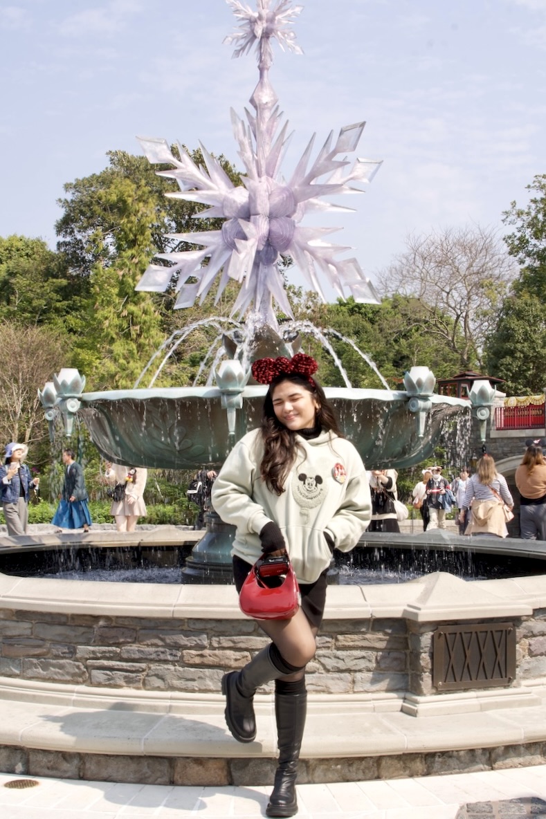 Nadz smiling and posing in Hong Kong Disneyland's World of Frozen area
