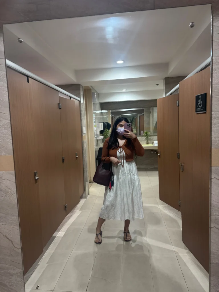 iPhone mirror selfie in a hospital restroom before skin biopsy for erythema nodosum