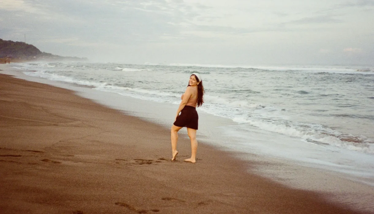 Nadz looking back, smiling at the beach