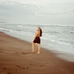 Nadz looking back, smiling at the beach
